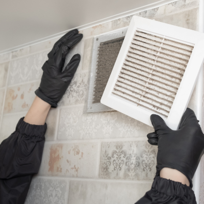 Technician inspecting the inside of ductwork