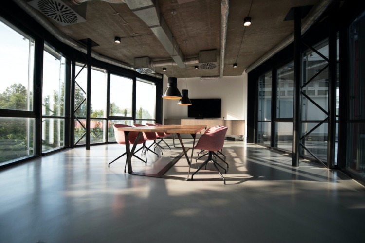 Modern office with large windows and exposed ductwork