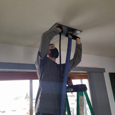 Technician performing air duct sanitizing service