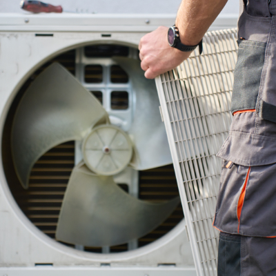 Colorado home with technician checking outdoor HVAC equipment