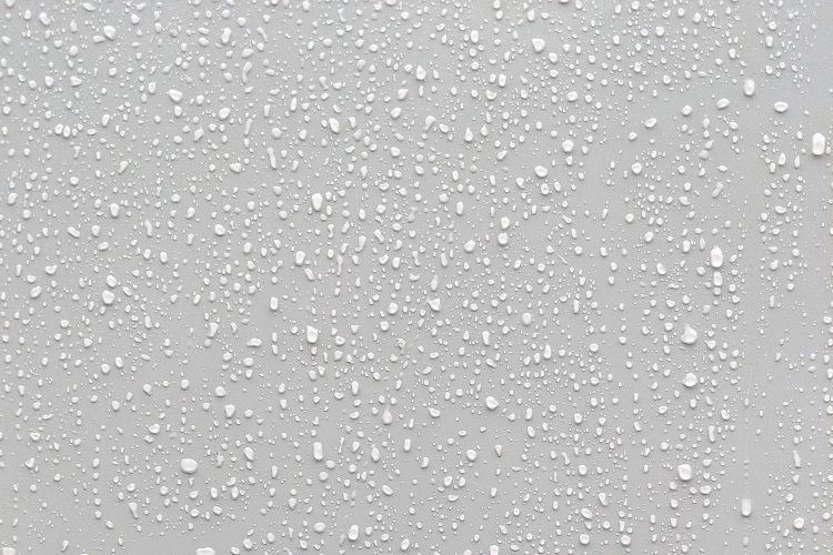 Droplets of condensation on flat, gray surface